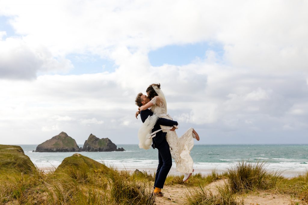bride and groom kissing on beach in Cornwall