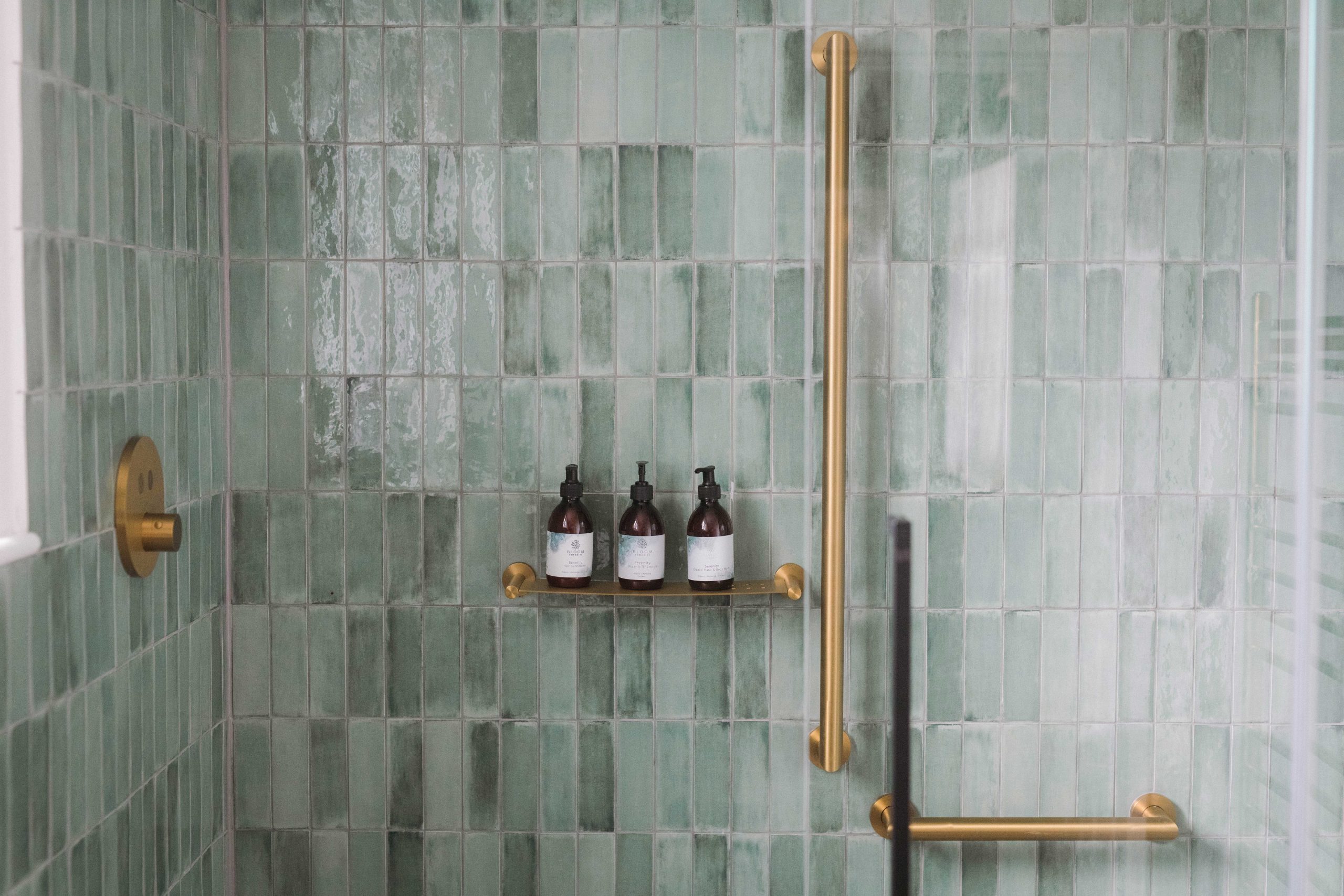 wheelchair accessible wedding venue stylish green tiles and gold grab rails