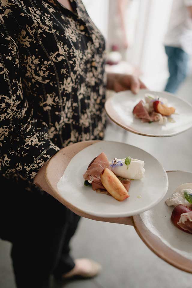 fine dining plates being served at small wedding