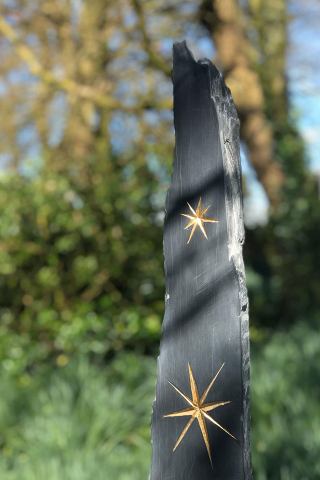 Gold star detail in carved slate sign