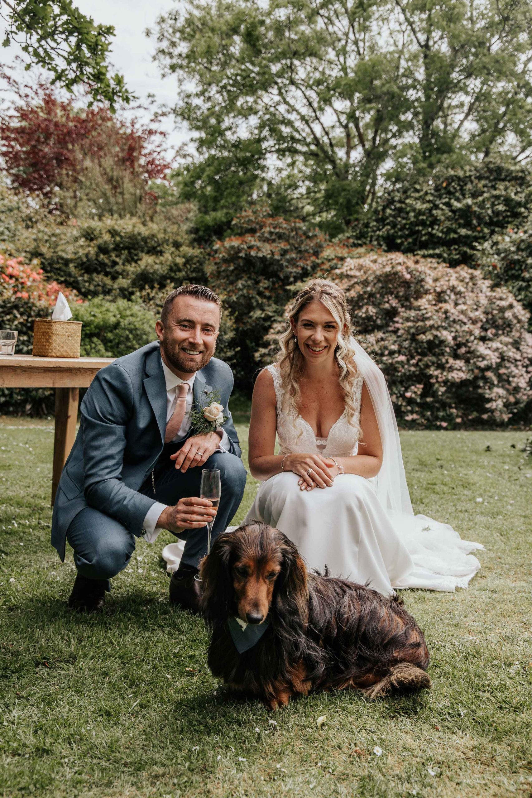 Dog and bride and groom at wedding venue in Cornwall