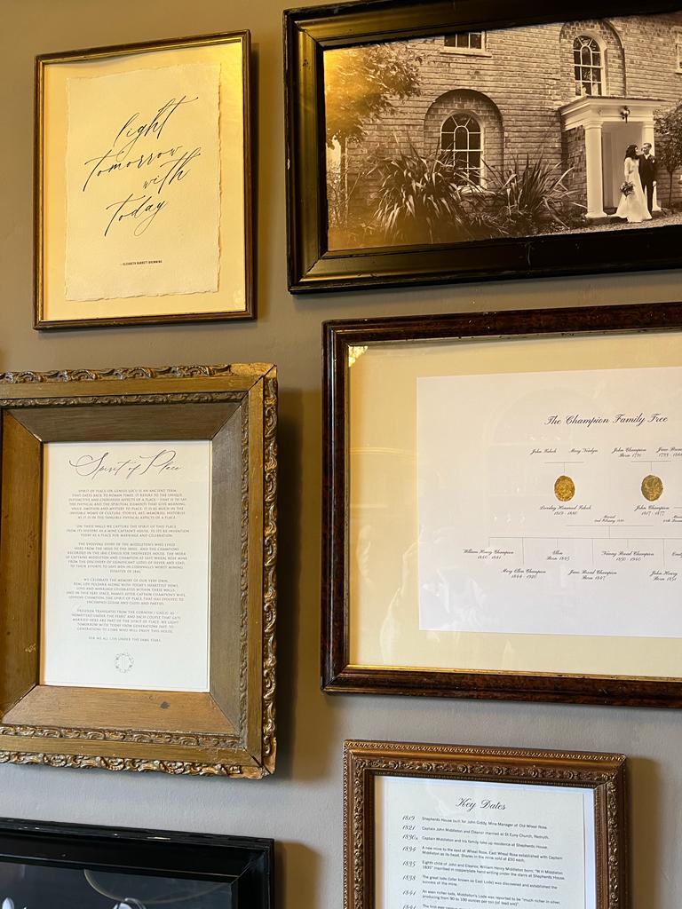 History wall in Lovedays Bar with history of Treseren house in vintage frames