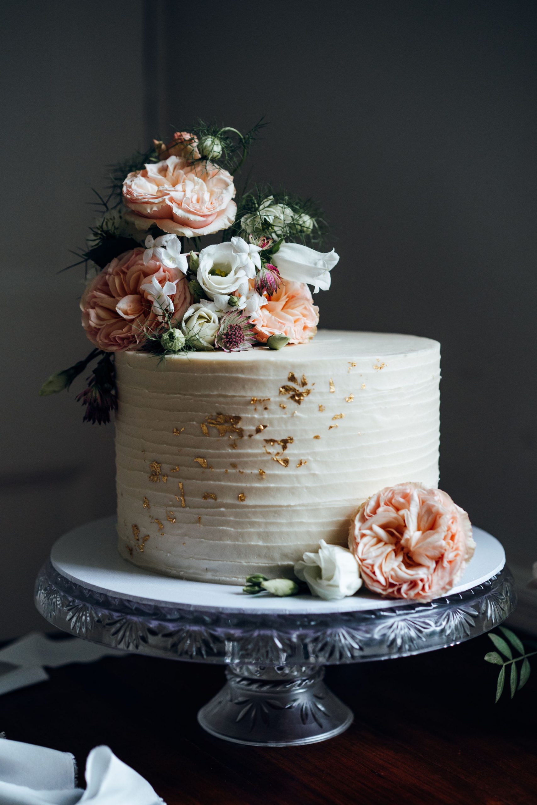 elegant small wedding cake at Treseren with pink flowers and gold