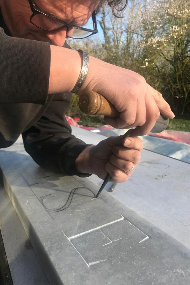 Ben Dearnley marking out letters for Treseren sign in marble