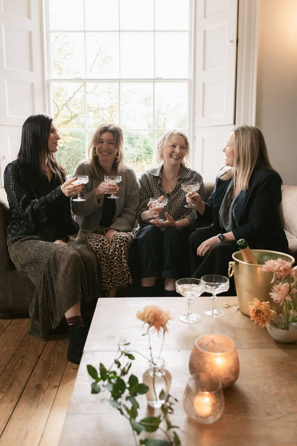 Treseren team drinking champagne on sofa wedding coordinators