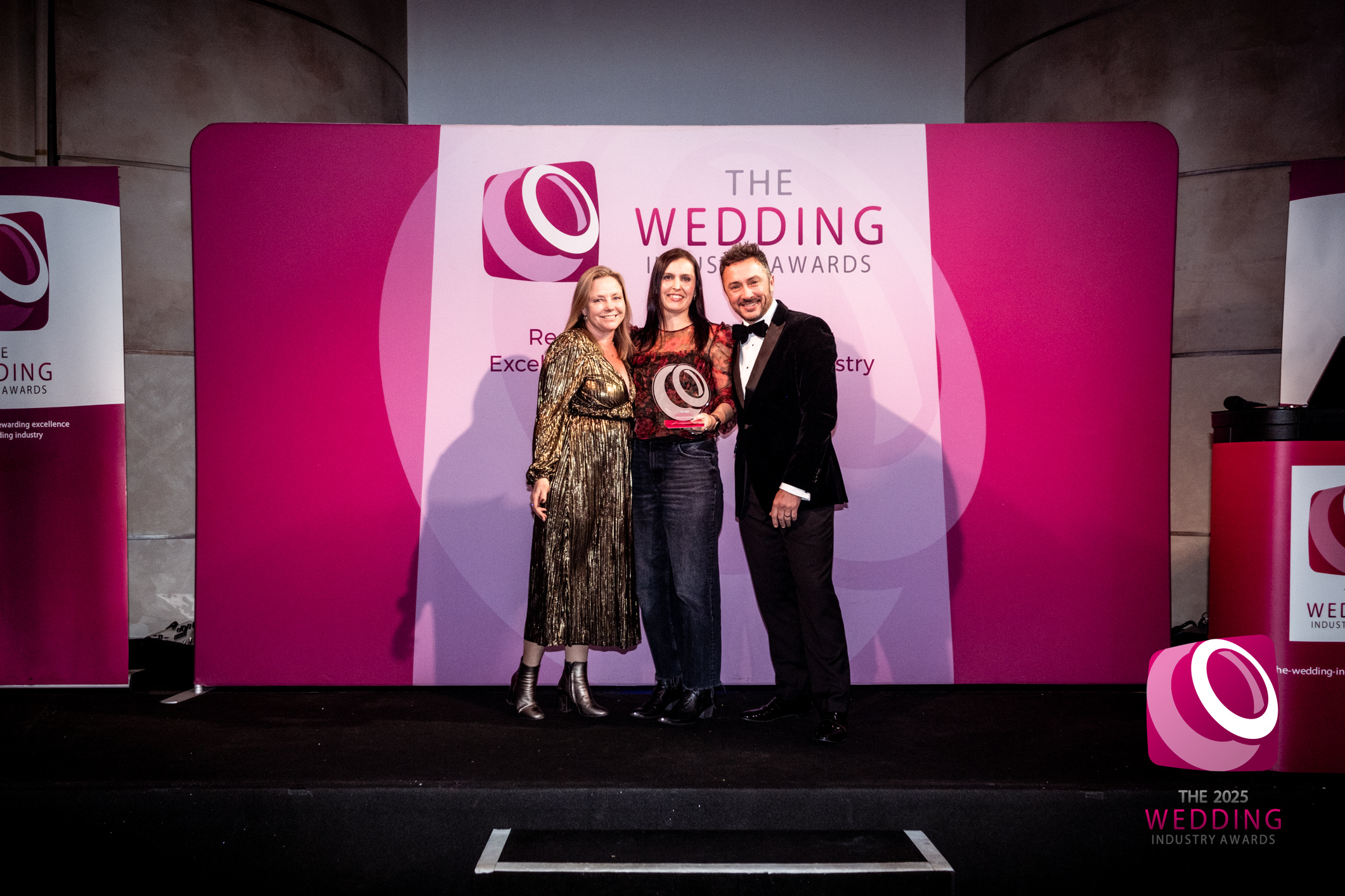 Emma and Izzy from Treseren collect award from Damian Bailey at the Wedding Industry Awards 2025 TWIA