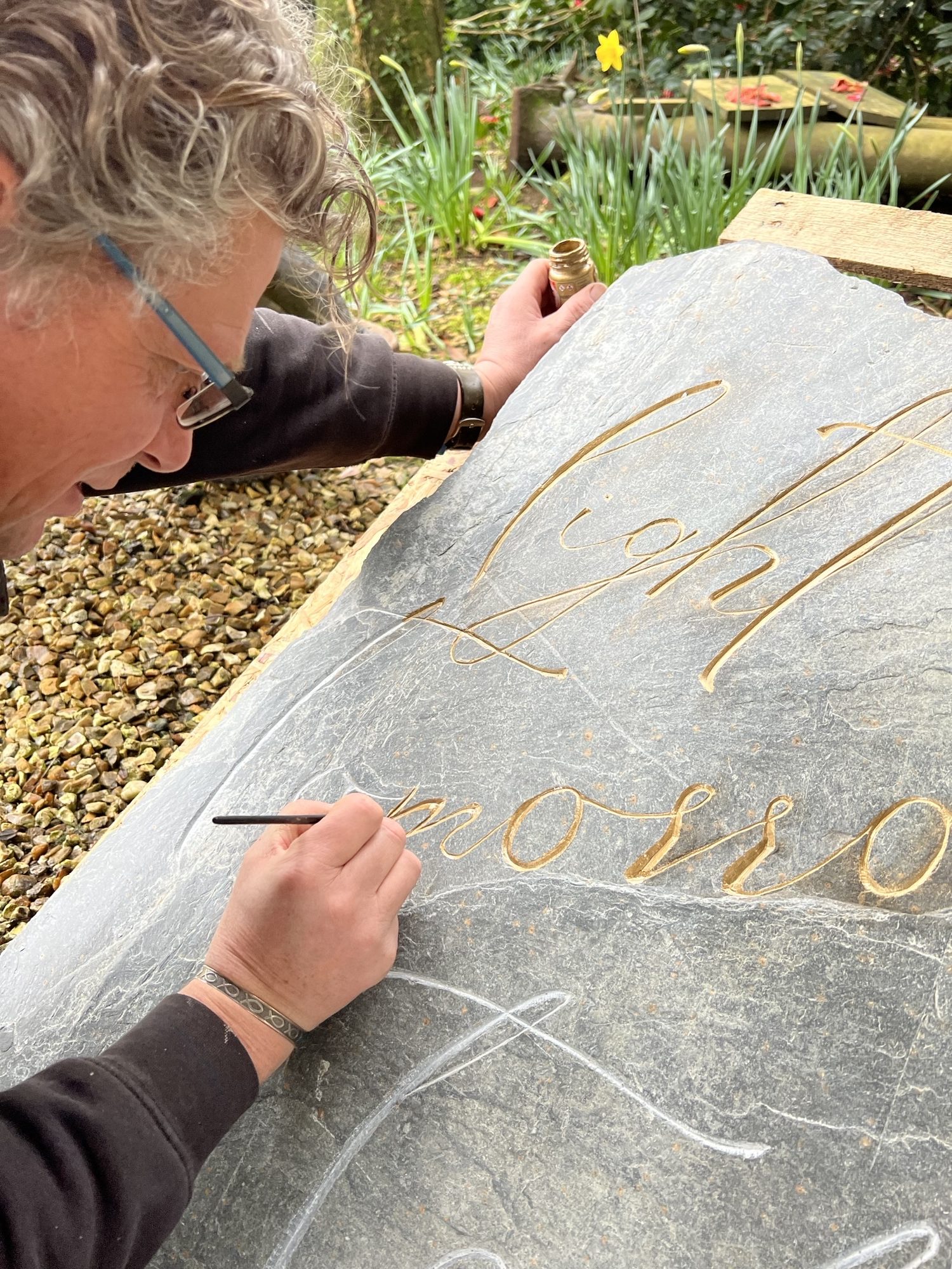 gold leaf being added to slate Treseren sign