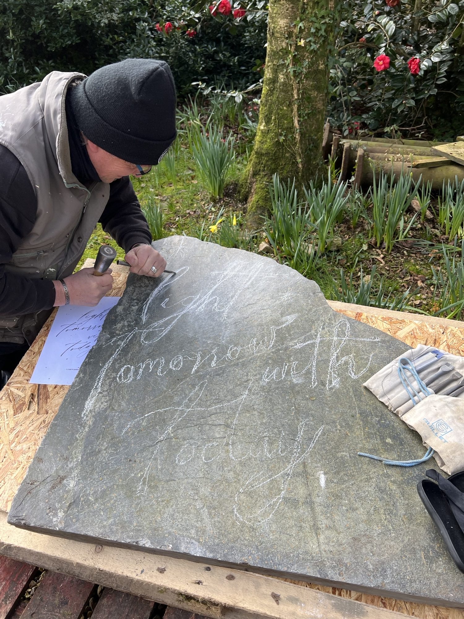 Ben Dearnley marking out words on poets stone at Treseren