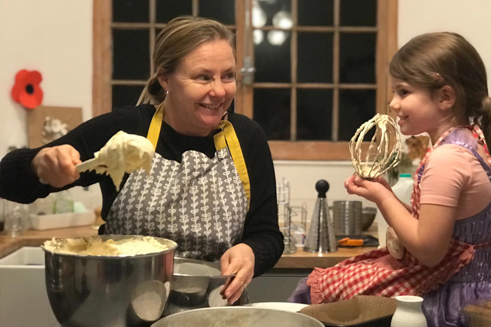 mother and daughter baking in kitchen