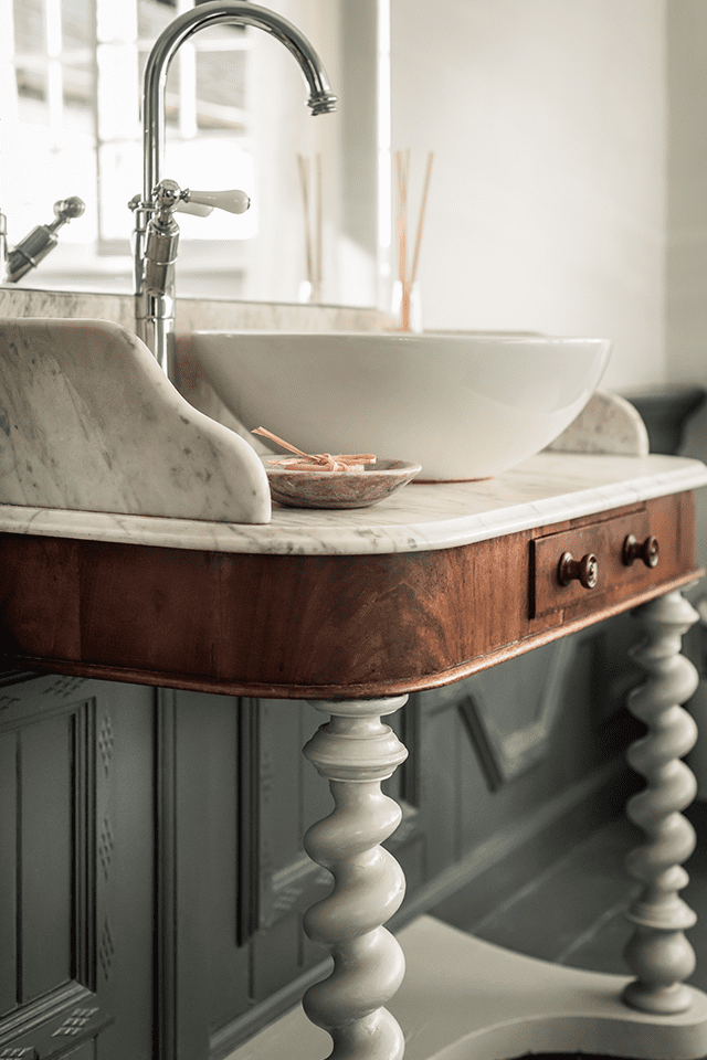 Marble top vintage bathroom washstand with modern sink basin and shade of grey panelling