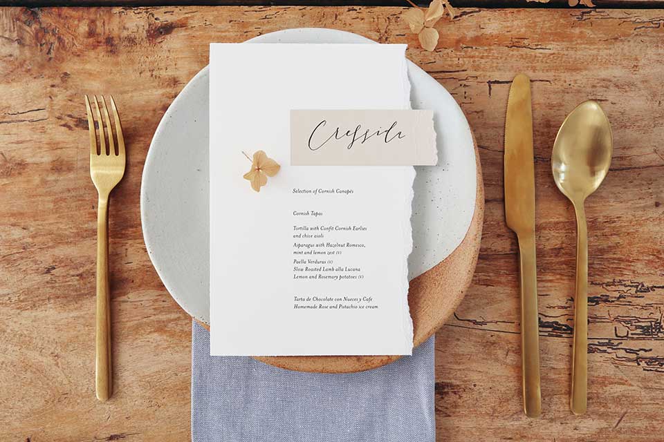 elegant styled wedding table place setting with salt glazed plate and gold cutlery