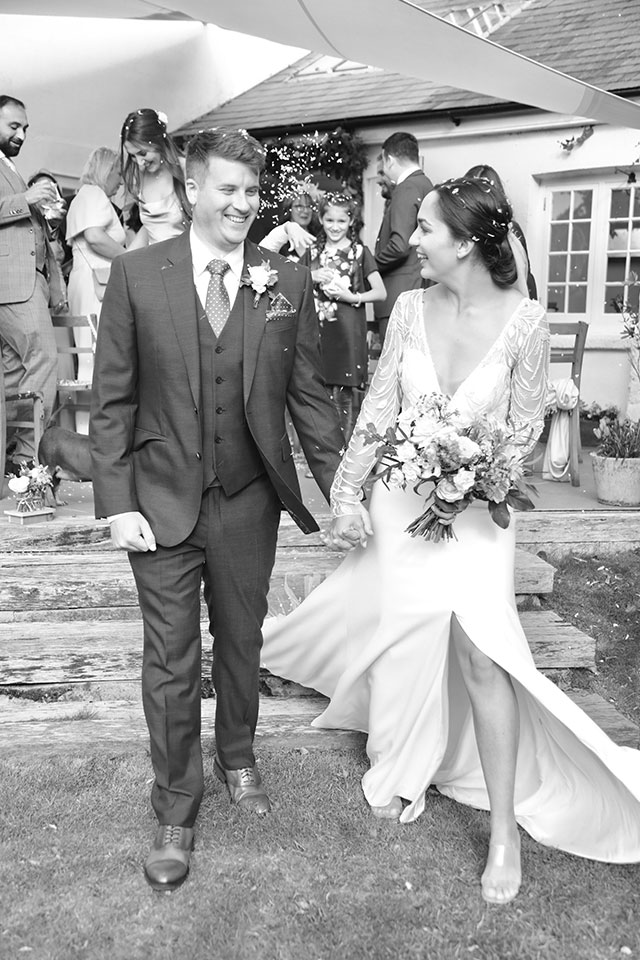 smiling bride and groom with bouquet